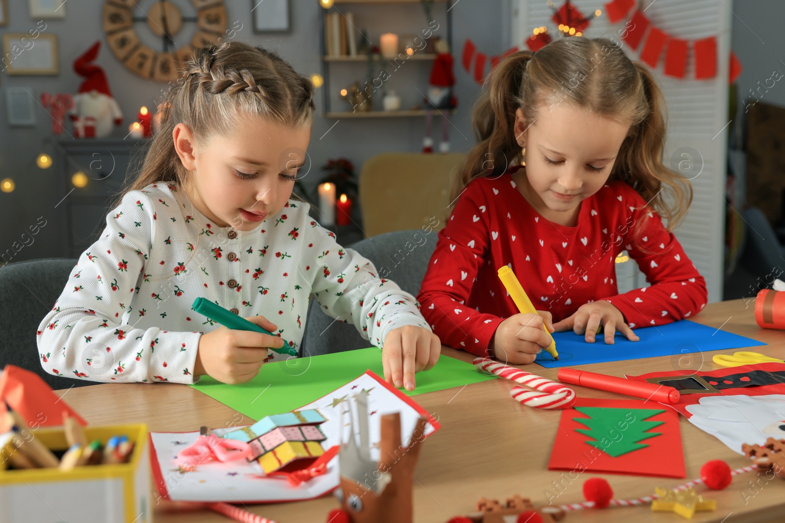 Photo of Cute little children making beautiful Christmas greeting cards at home