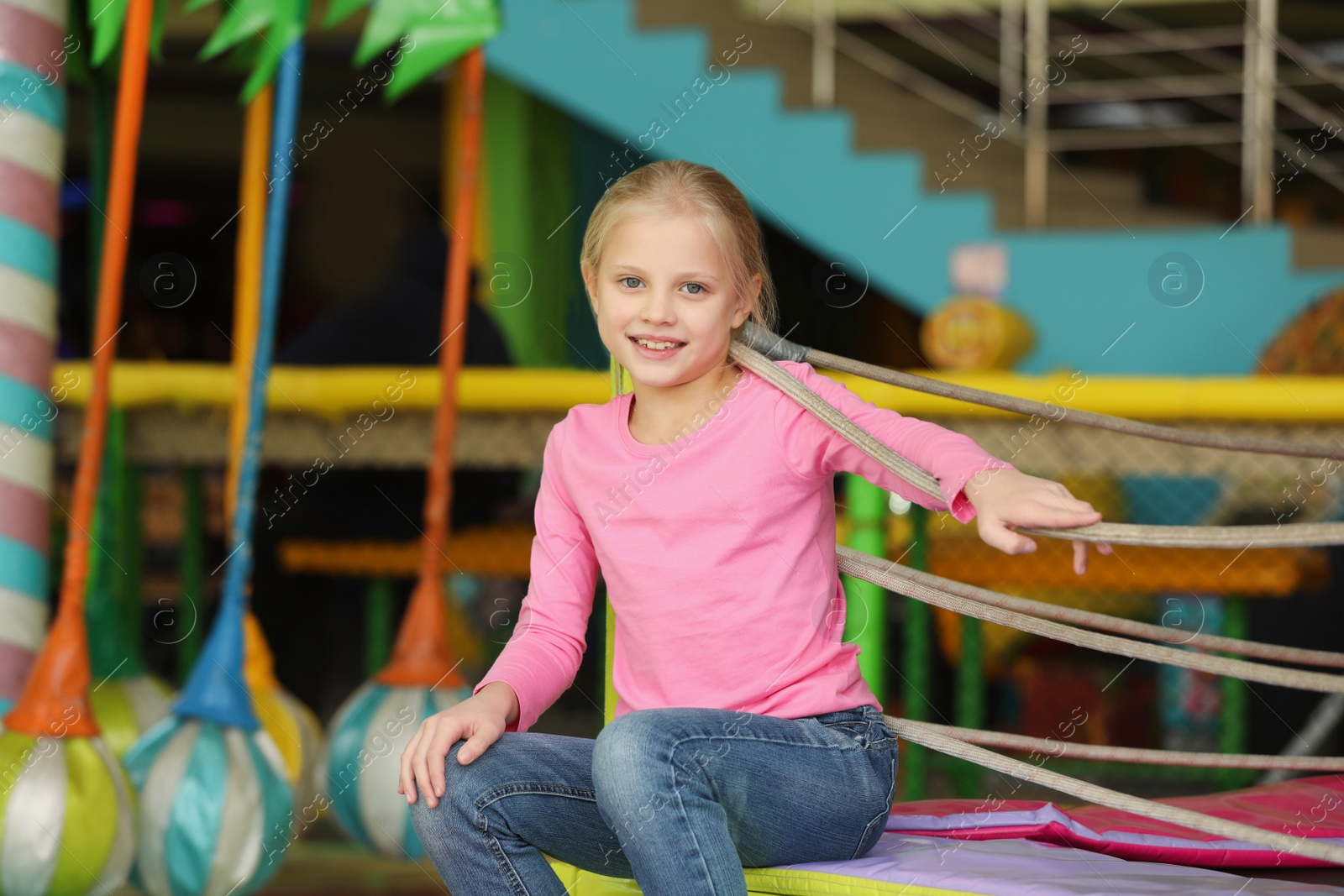 Photo of Cute little child playing at indoor amusement park