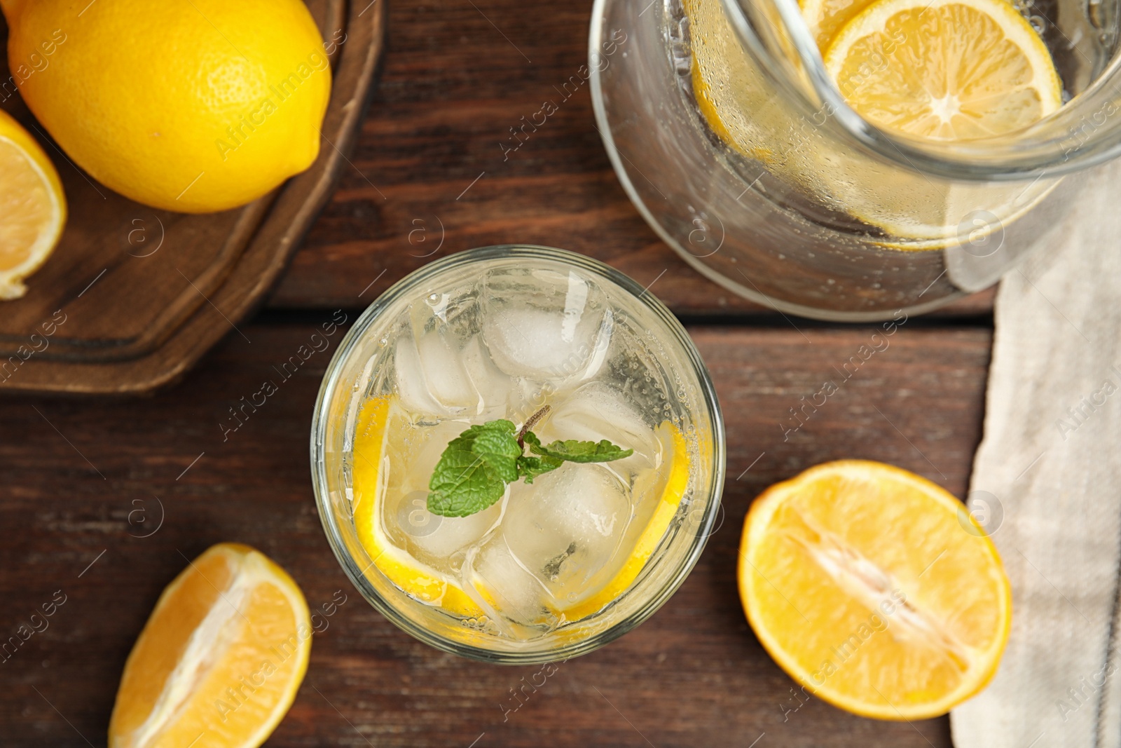 Photo of Cool freshly made lemonade and fruits on wooden table, flat lay