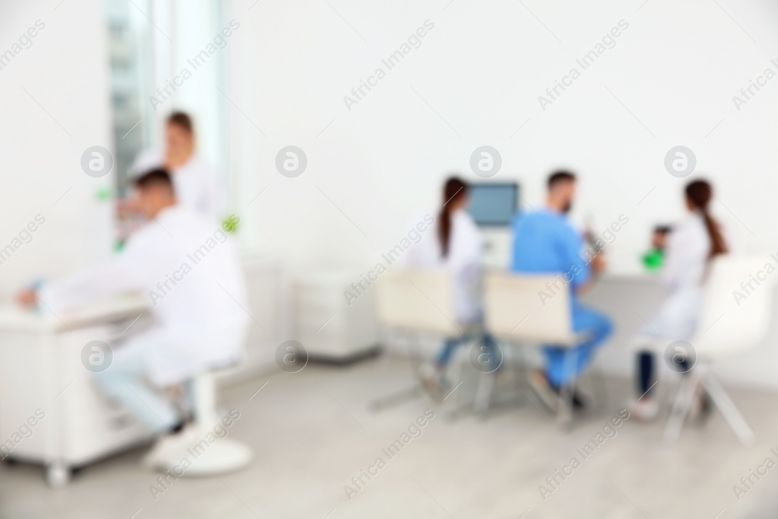 Photo of Blurred view of medical students working in scientific laboratory