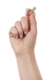 Photo of Woman holding vitamin capsule on white background, closeup. Health supplement