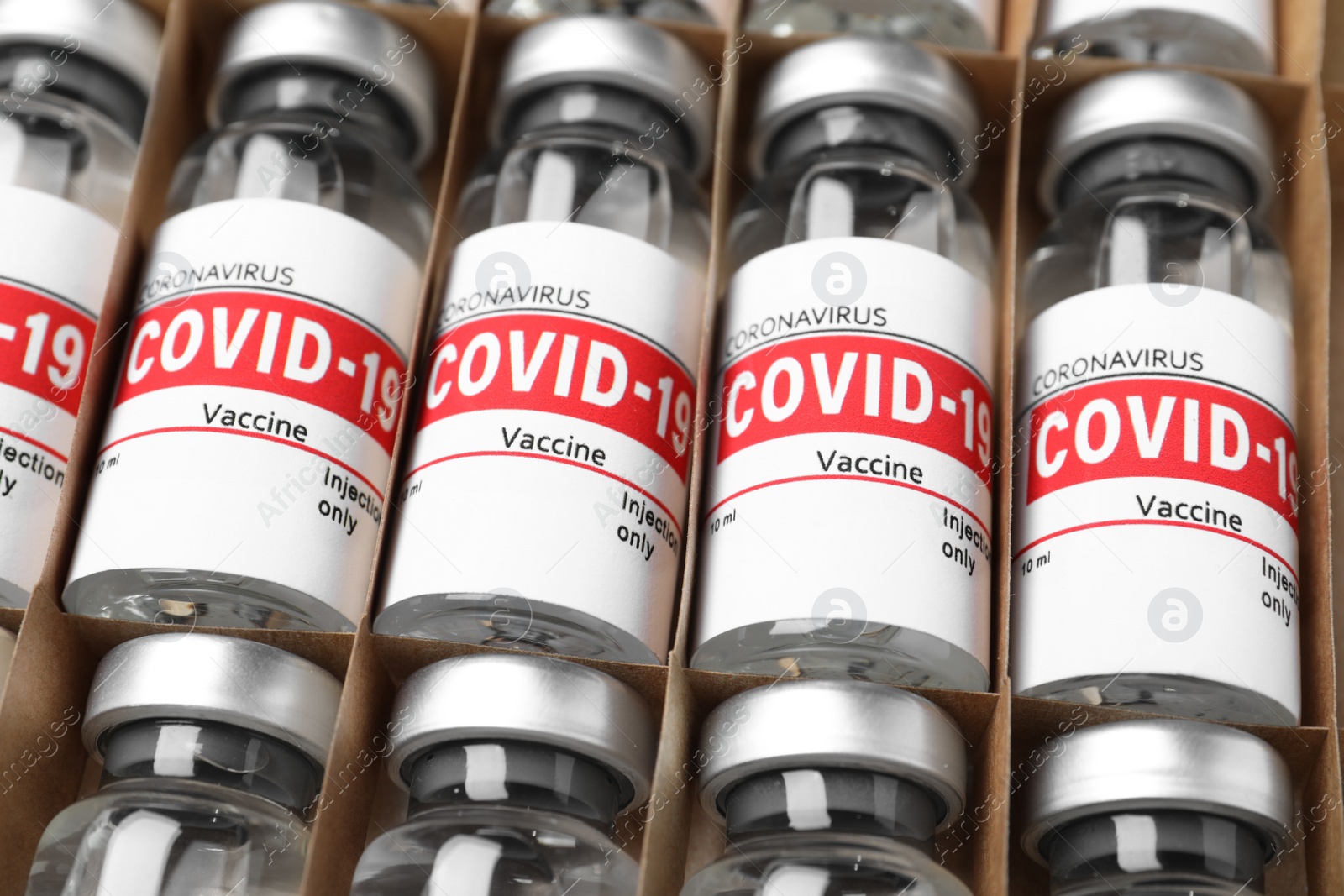 Photo of Glass vials with COVID-19 vaccine in package, closeup