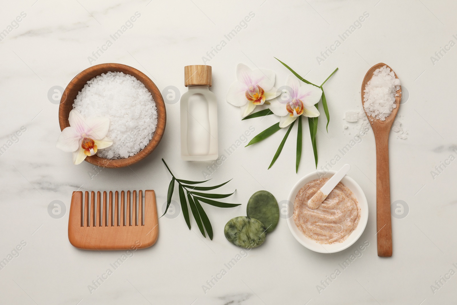 Photo of Flat lay composition with different spa products and flowers on white marble table