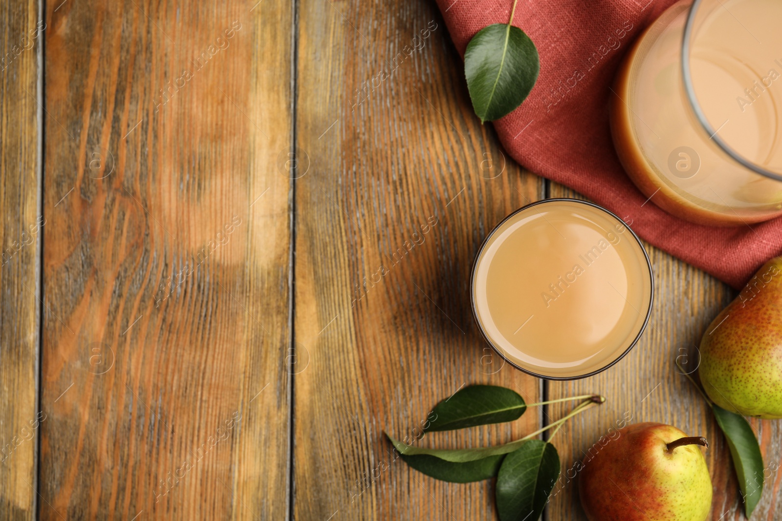 Photo of Tasty pear juice, fruits and leaves on wooden table, flat lay. Space for text