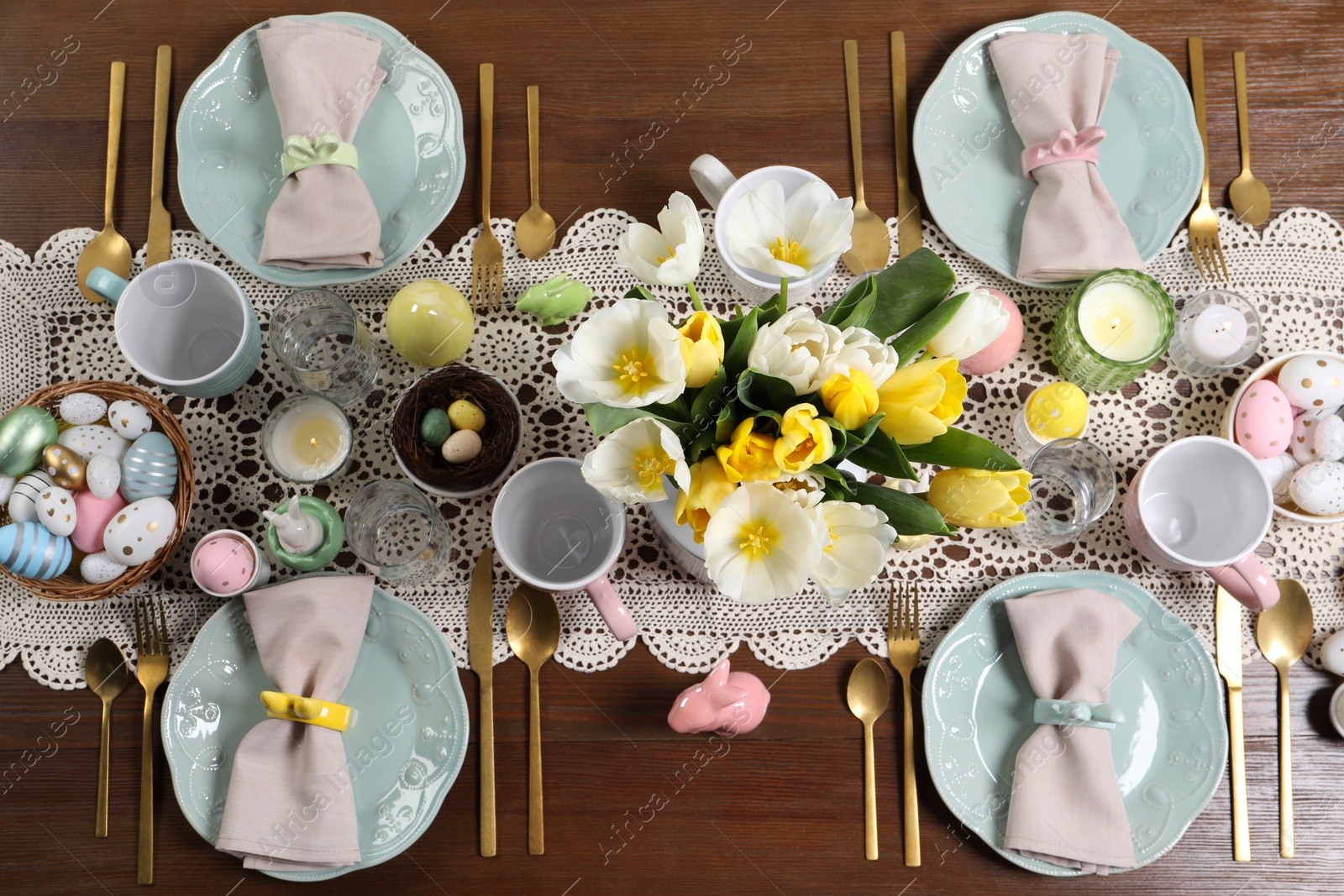 Photo of Festive table setting with beautiful flowers, flat lay. Easter celebration