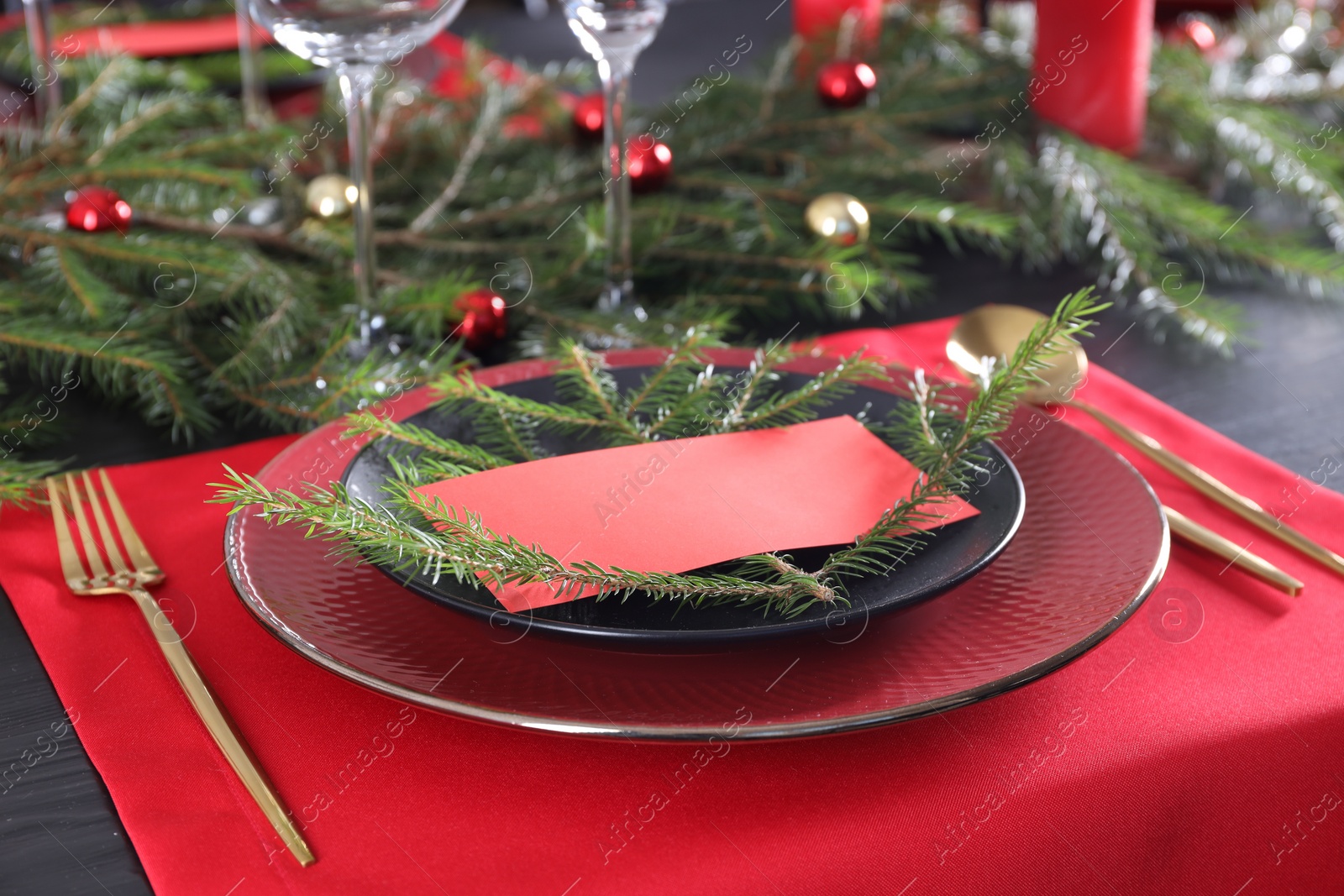 Photo of Elegant Christmas place setting with blank card and festive decor on table