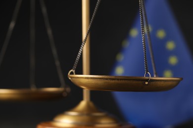 Photo of Scales of justice against European Union flag, closeup
