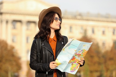Photo of Traveler with world map on city street