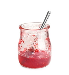 Jar with leftovers of sweet jam on white background