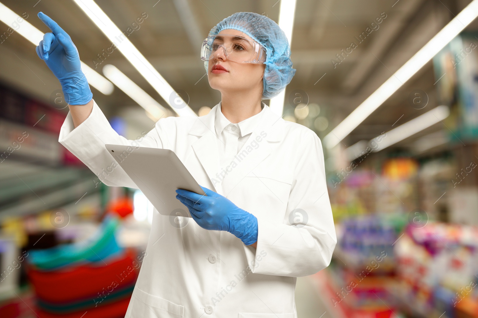 Image of Food quality control specialist examining products in supermarket