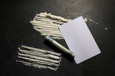 Photo of Drug addiction. Cocaine, rolled dollar banknote and blank card on grey textured background, flat lay