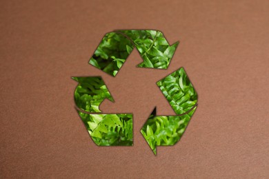 Image of Recycling symbol made of green leaves on kraft paper