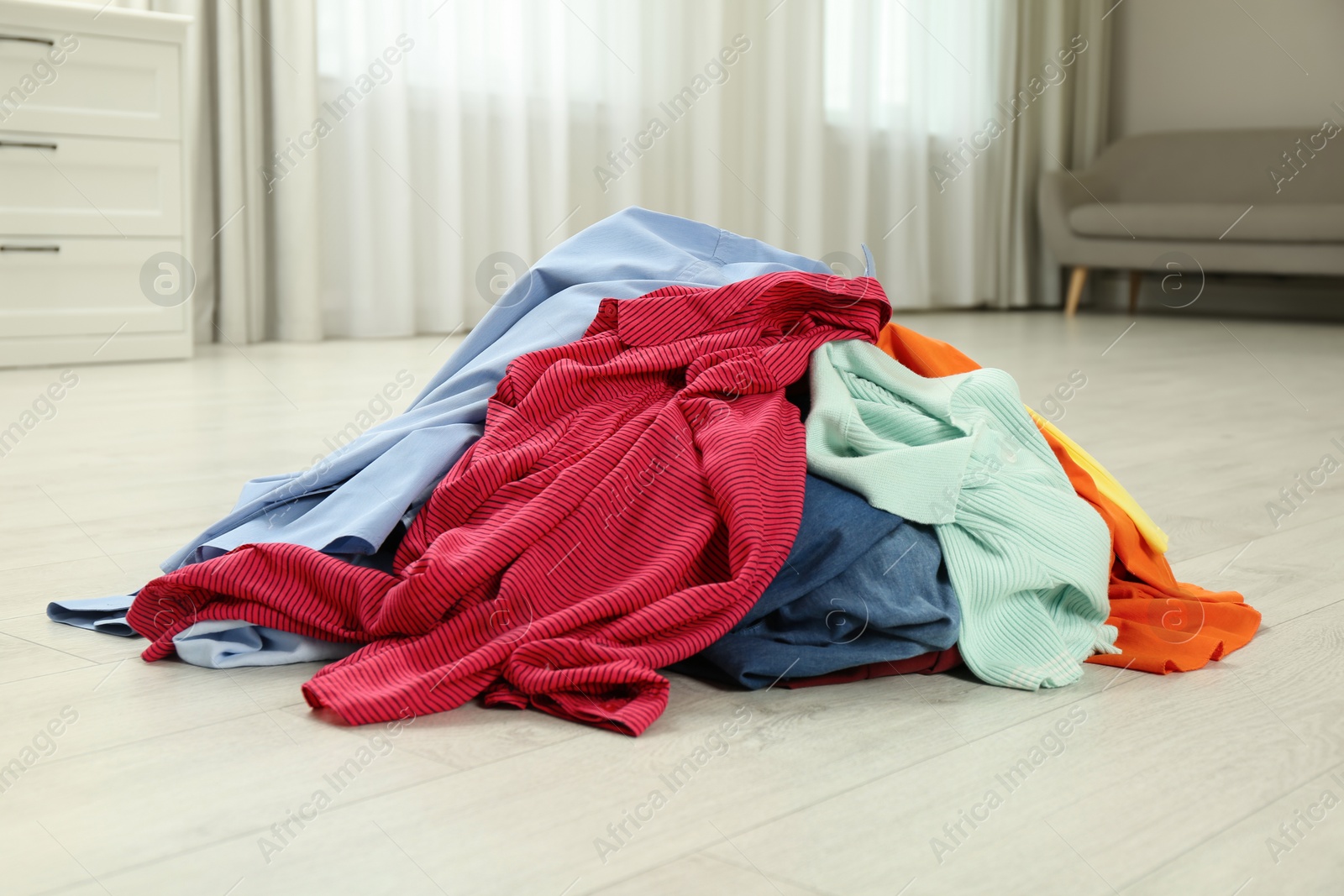Photo of Pile of dirty clothes on floor indoors