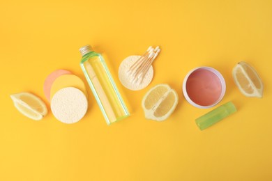 Photo of Lemon face cleanser. Fresh citrus fruits and personal care products on yellow background, flat lay