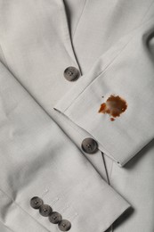 Photo of Dirty jacket with stain of coffee as background, closeup