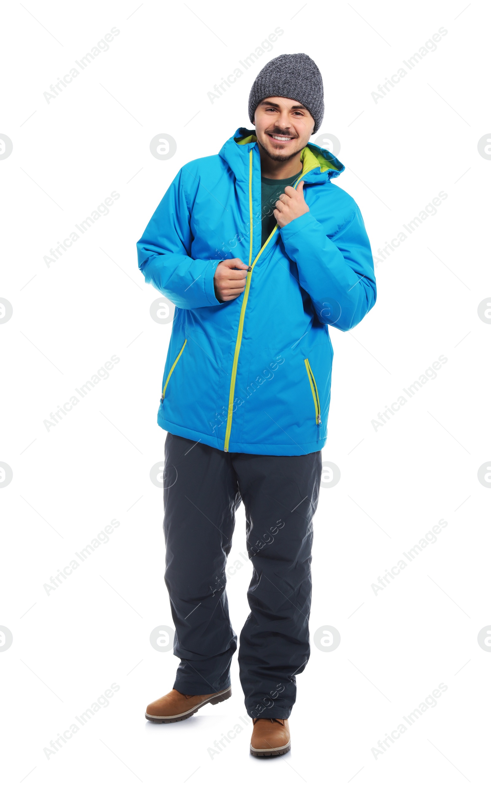 Photo of Young man wearing warm clothes on white background. Ready for winter vacation