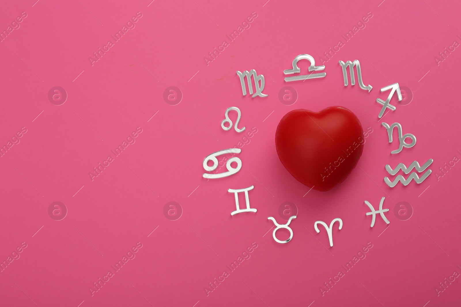 Photo of Zodiac signs and red heart on pink background, flat lay. Space for text