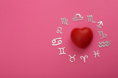 Zodiac signs and red heart on pink background, flat lay. Space for text