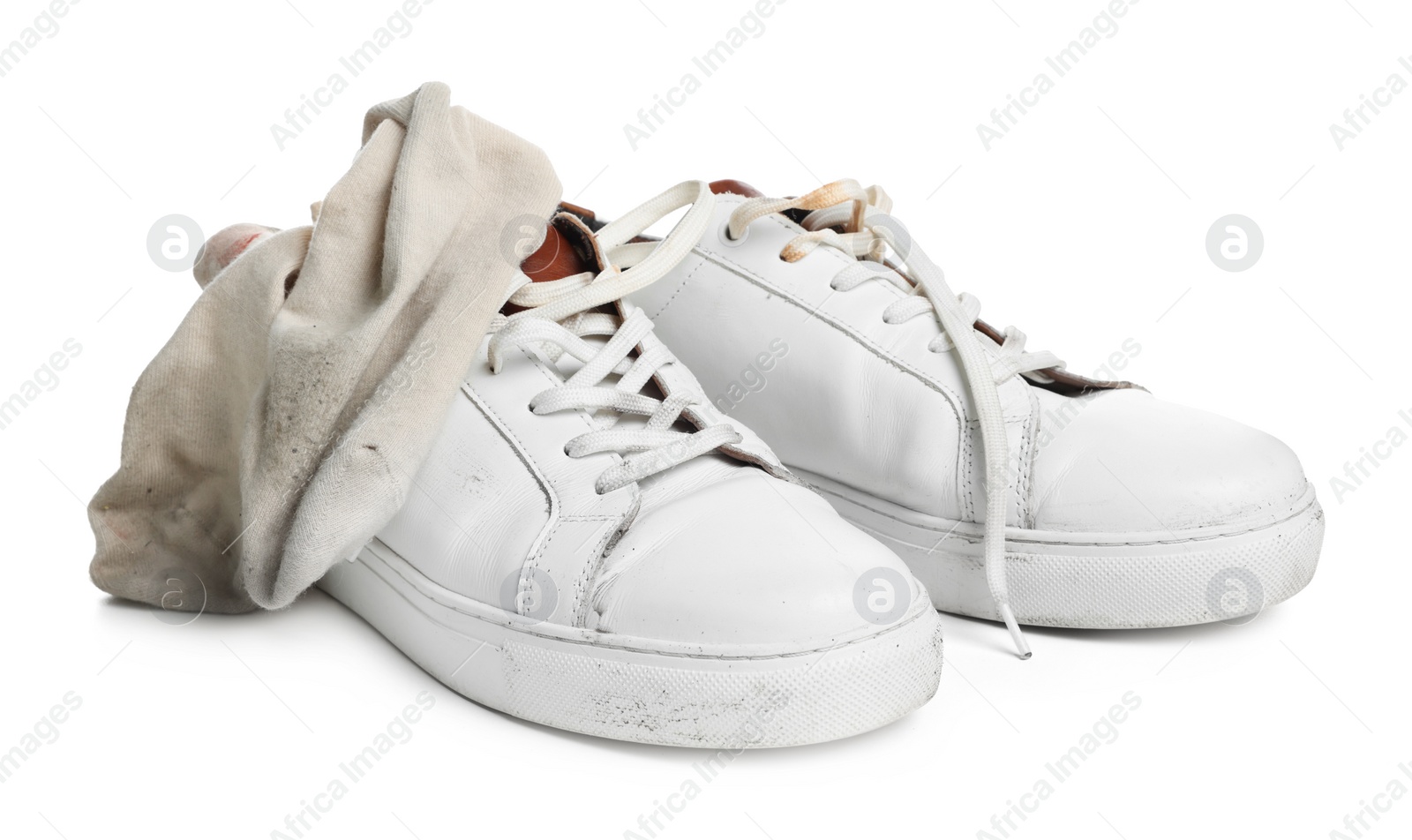 Photo of Dirty socks and sneakers on white background