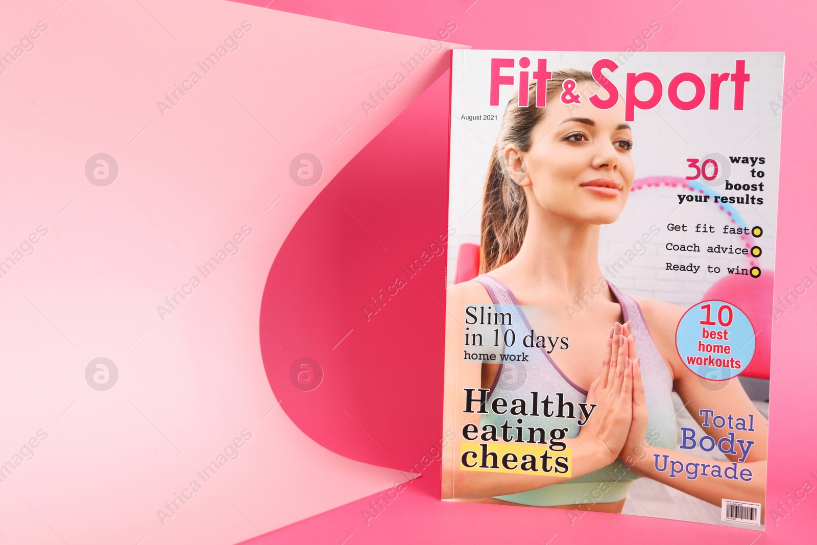 Photo of Modern printed sports magazine on pink background, space for text
