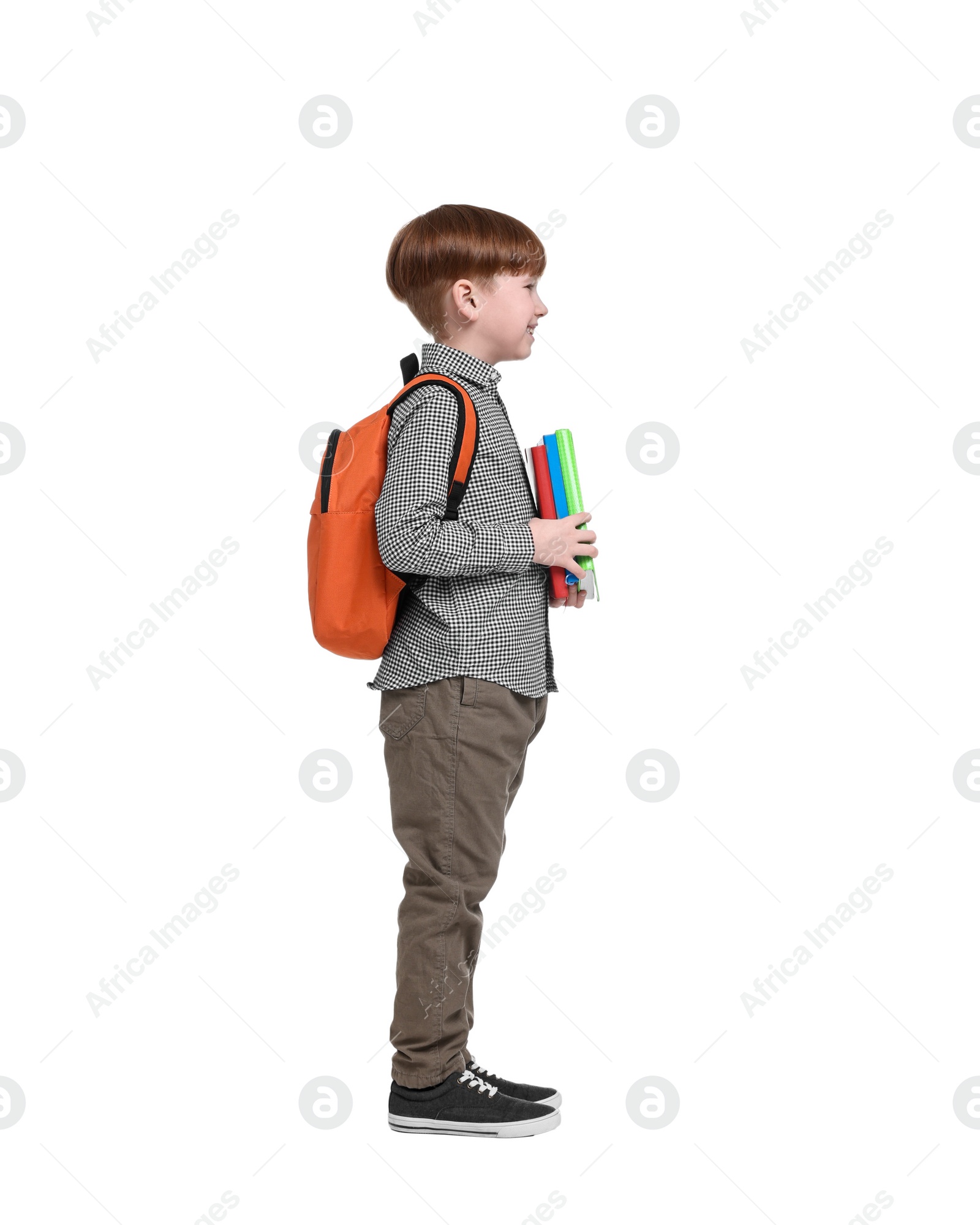 Photo of Little schoolboy with backpack and books on white background