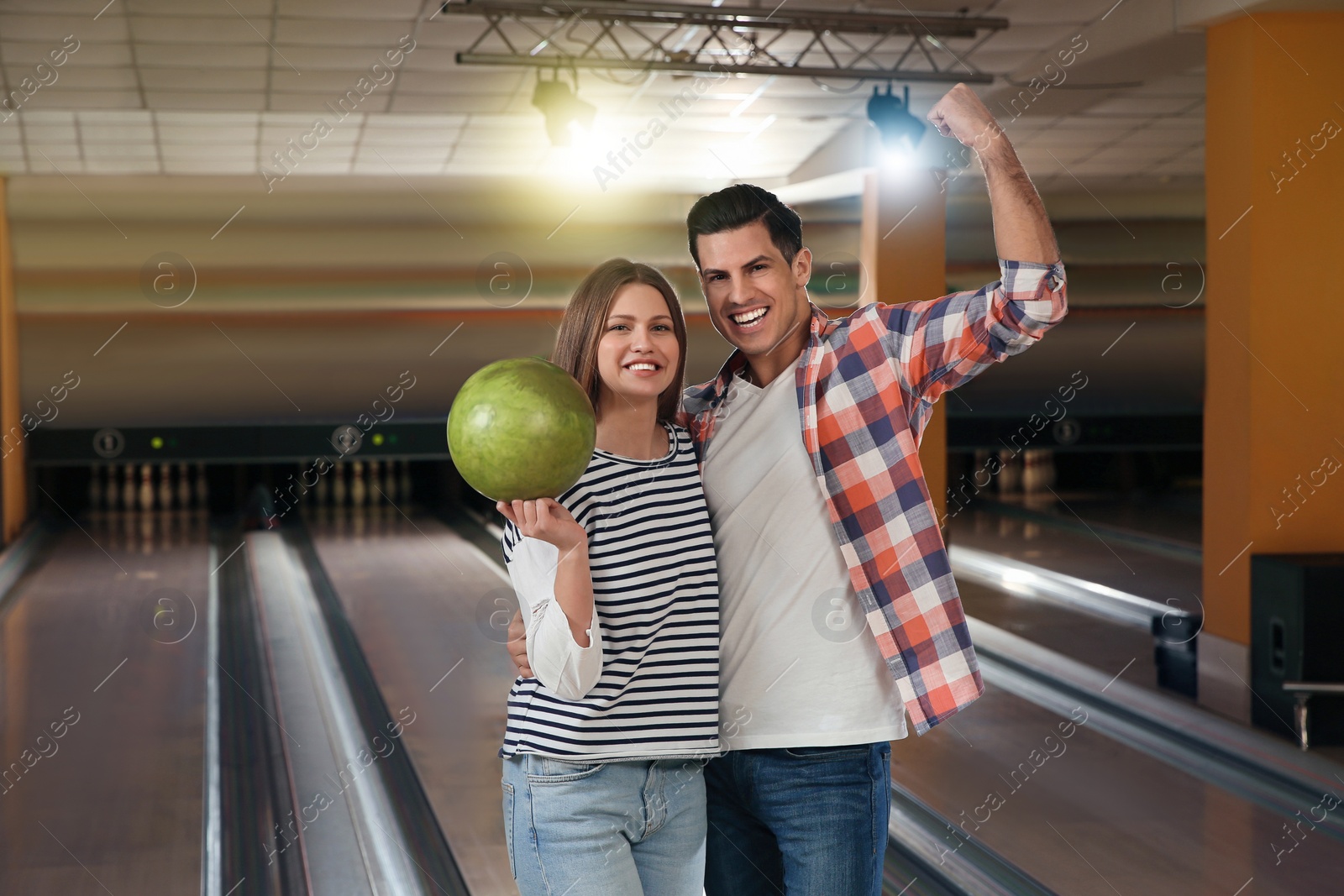 Photo of Happy couple with ball in bowling club