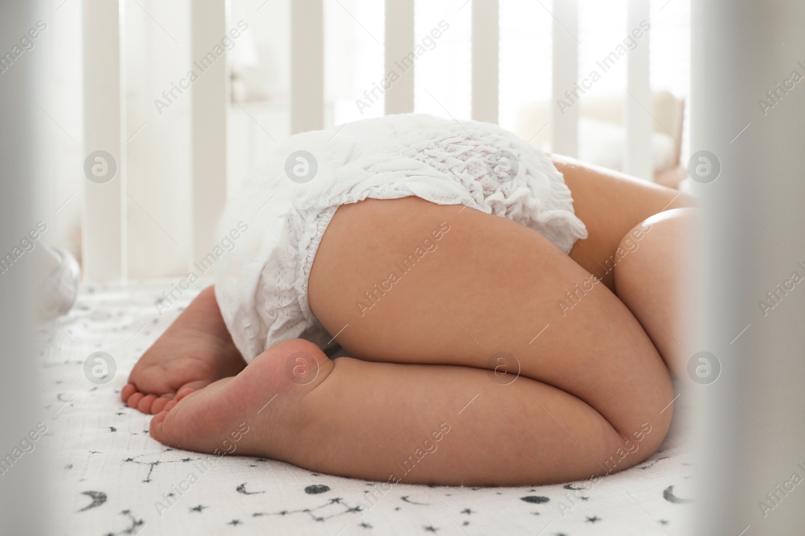 Photo of Cute little baby sleeping in crib at home, closeup