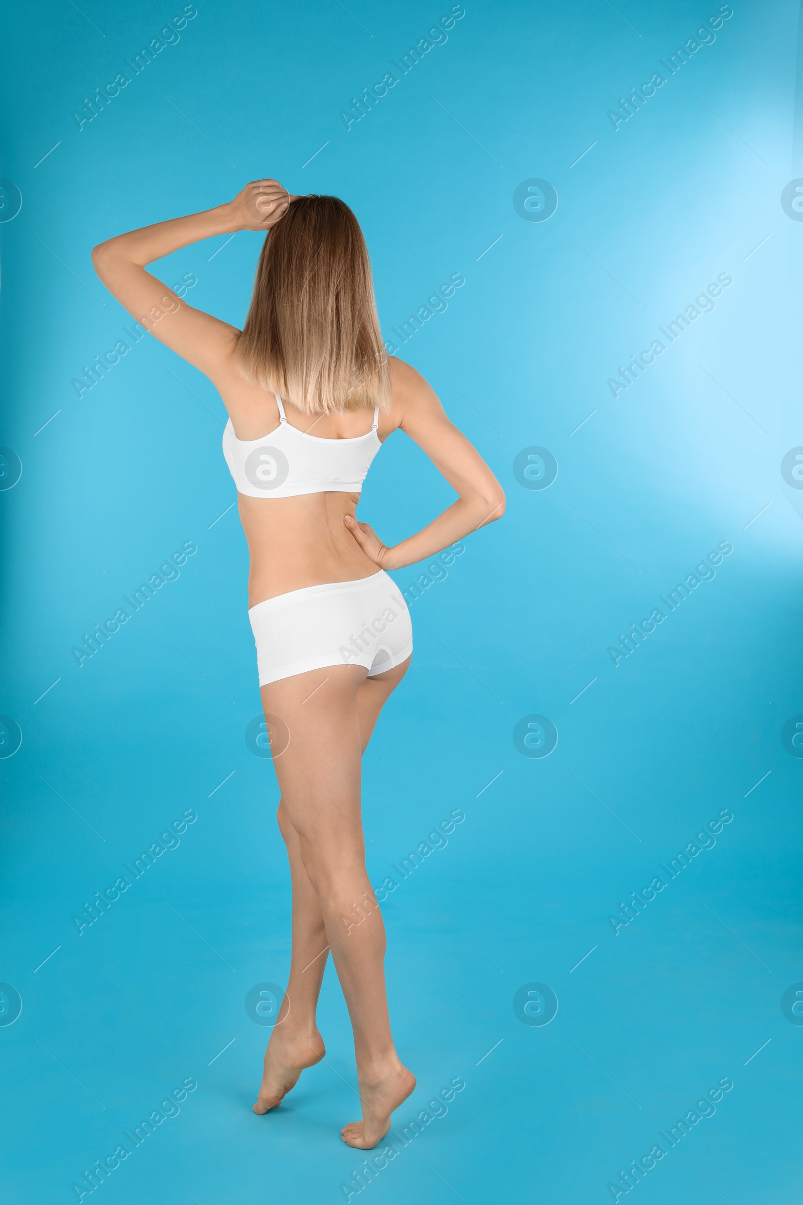 Photo of Young slim woman on color background, space for text. Perfect body