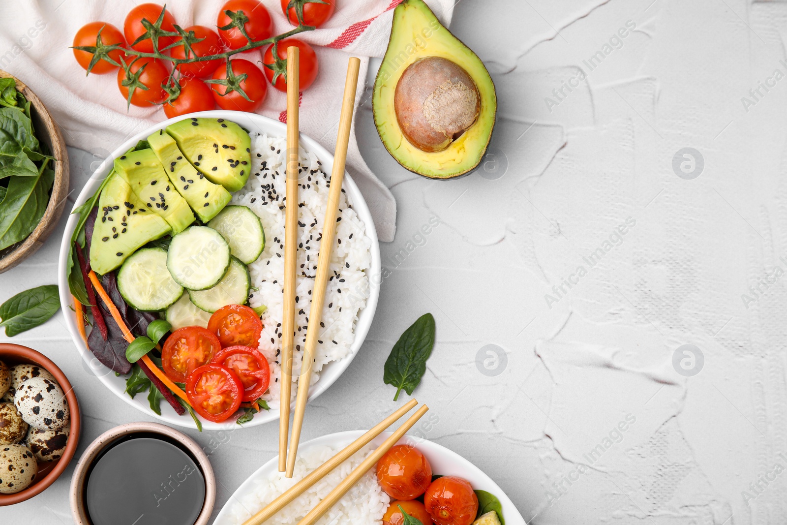 Photo of Delicious poke bowls and ingredients on white table, flat lay. Space for text