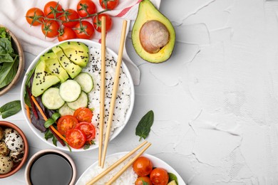 Delicious poke bowls and ingredients on white table, flat lay. Space for text