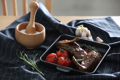 Photo of Delicious roasted ribs served on table indoors