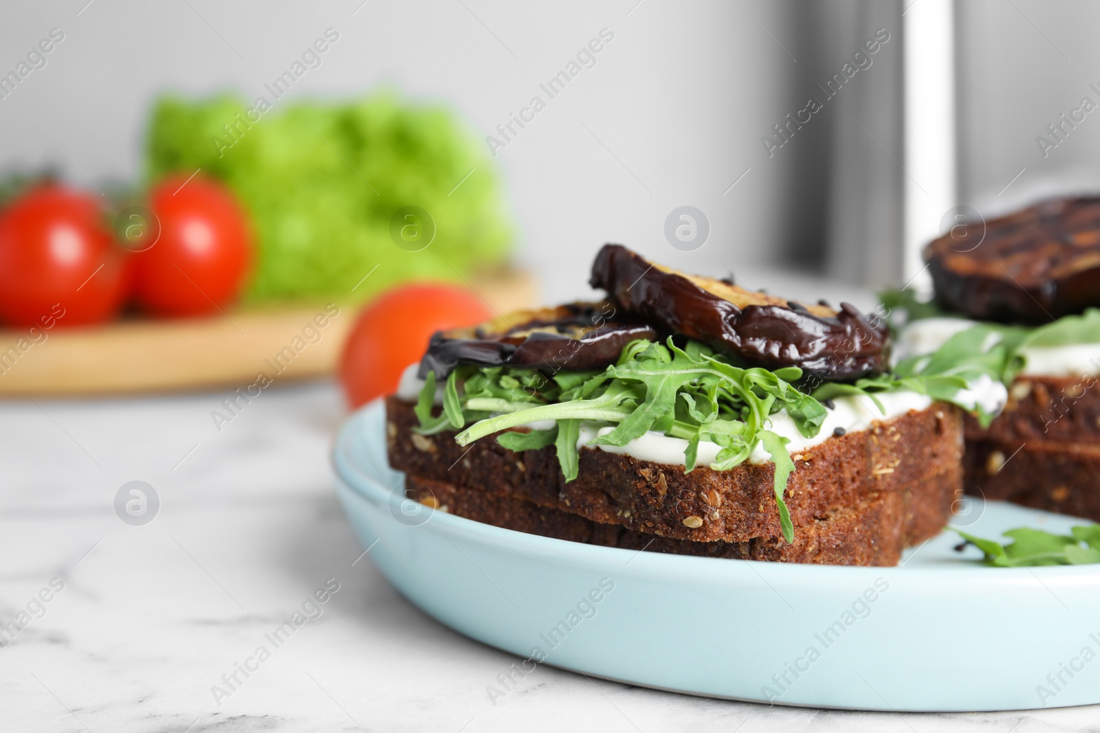 Photo of Delicious eggplant sandwiches on white marble table, closeup