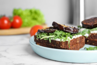 Delicious eggplant sandwiches on white marble table, closeup