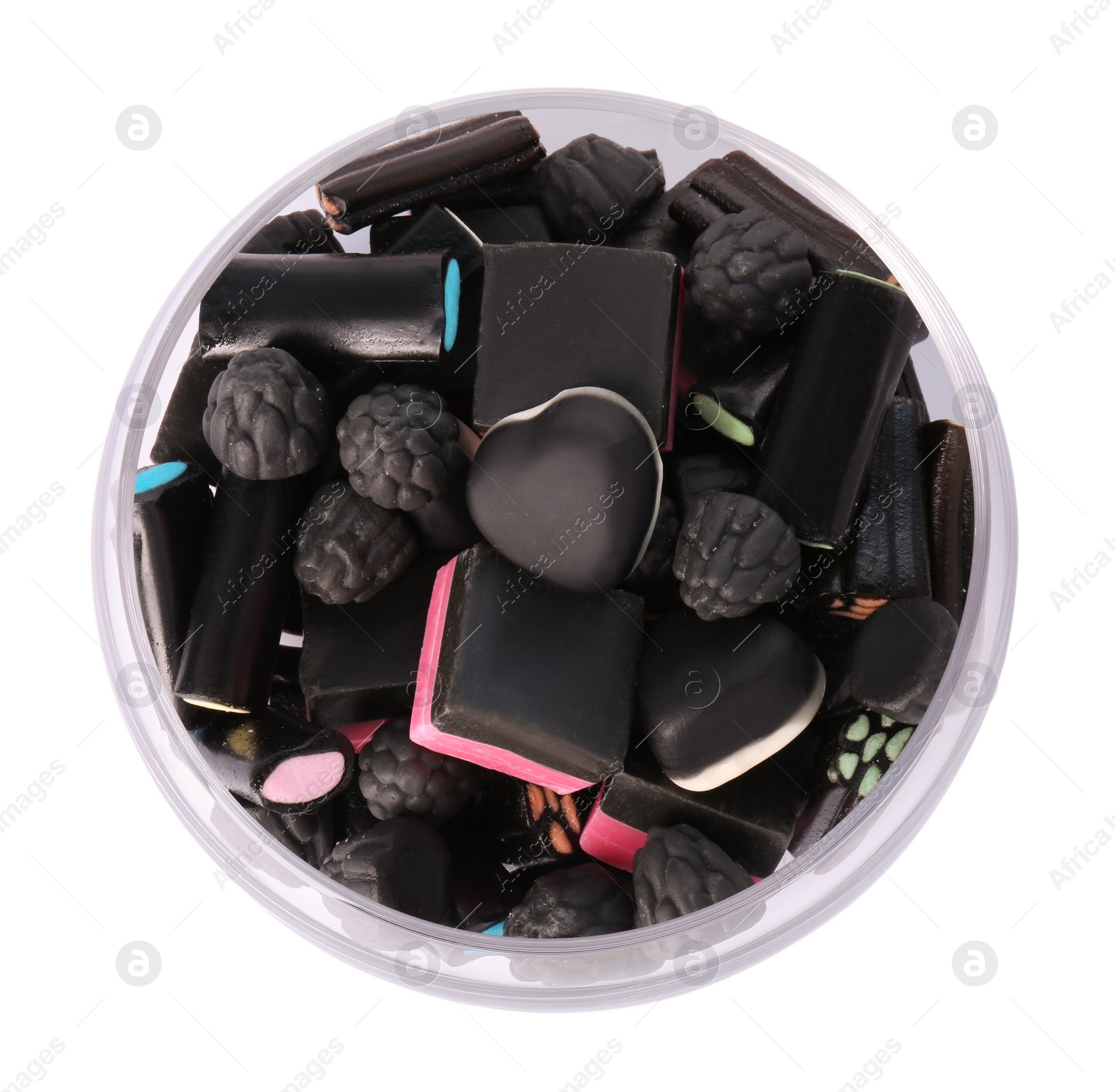 Photo of Glass bowl with many tasty liquorice candies isolated on white, top view