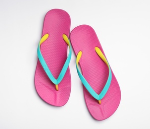 Photo of Pair of flip flops on white background, top view. Beach accessories