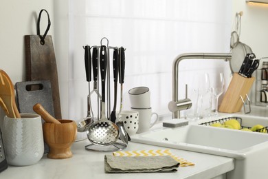 Photo of Countertop with sink and cooking utensils in kitchen