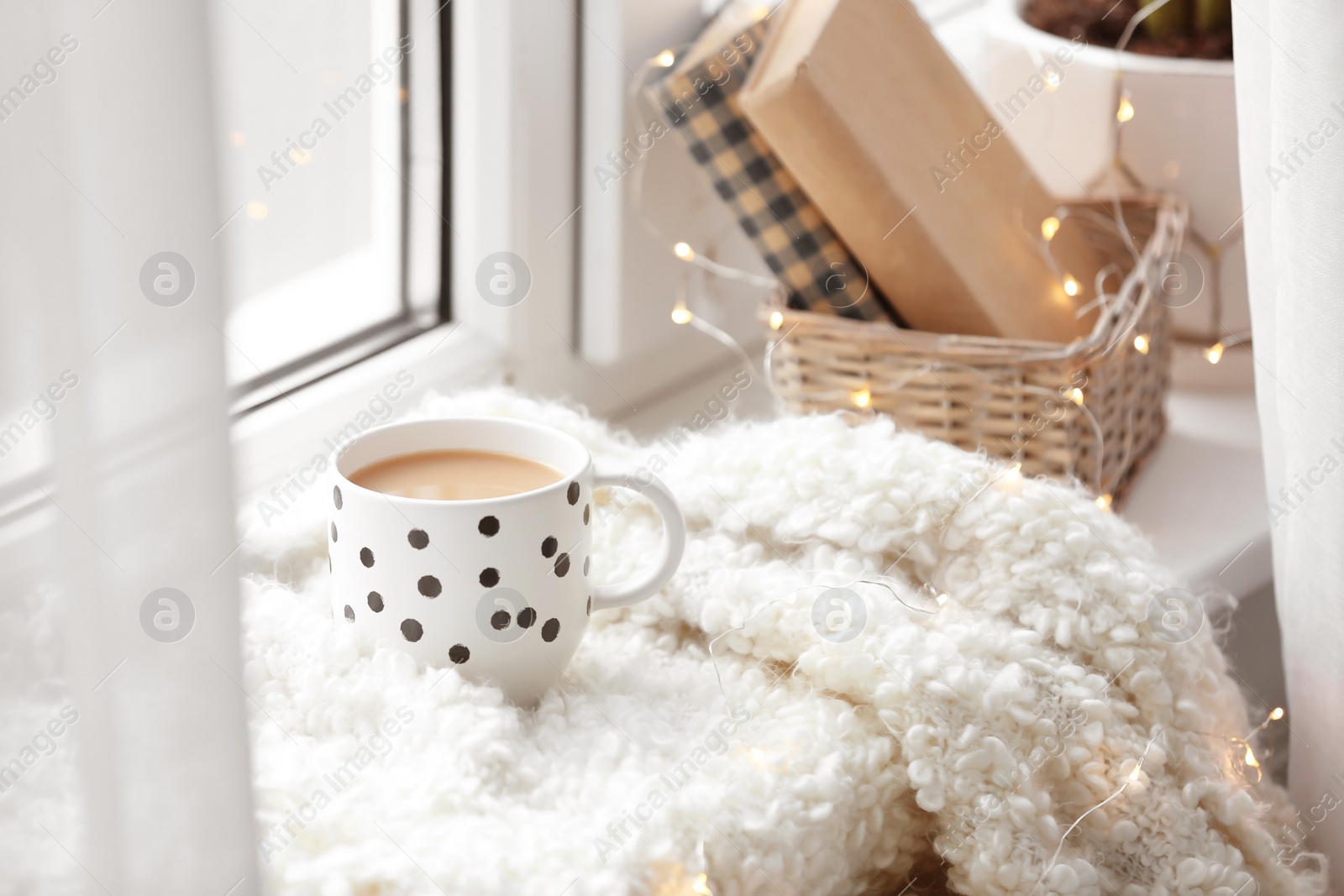 Photo of Cup of hot coffee on windowsill