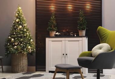 Photo of Beautiful room interior with decorated Christmas tree and modern furniture