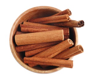 Photo of Aromatic cinnamon sticks in bowl isolated on white, top view