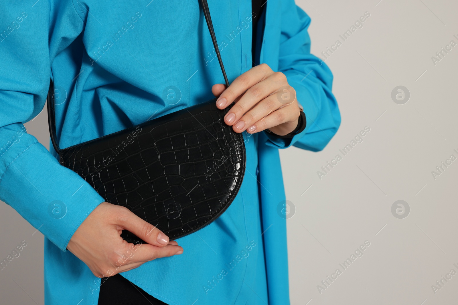 Photo of Woman with stylish bag on white background, closeup. Space for text