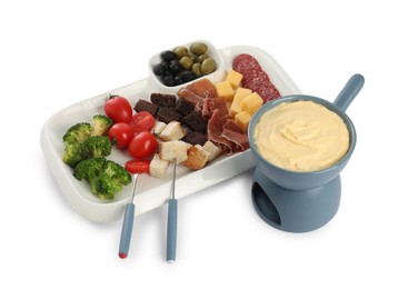 Fondue with tasty melted cheese, forks and different snacks isolated on white