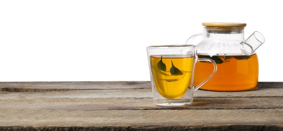 Refreshing green tea in cup and teapot on wooden table against white background