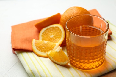 Board with tasty jelly and orange slices on light table, space for text