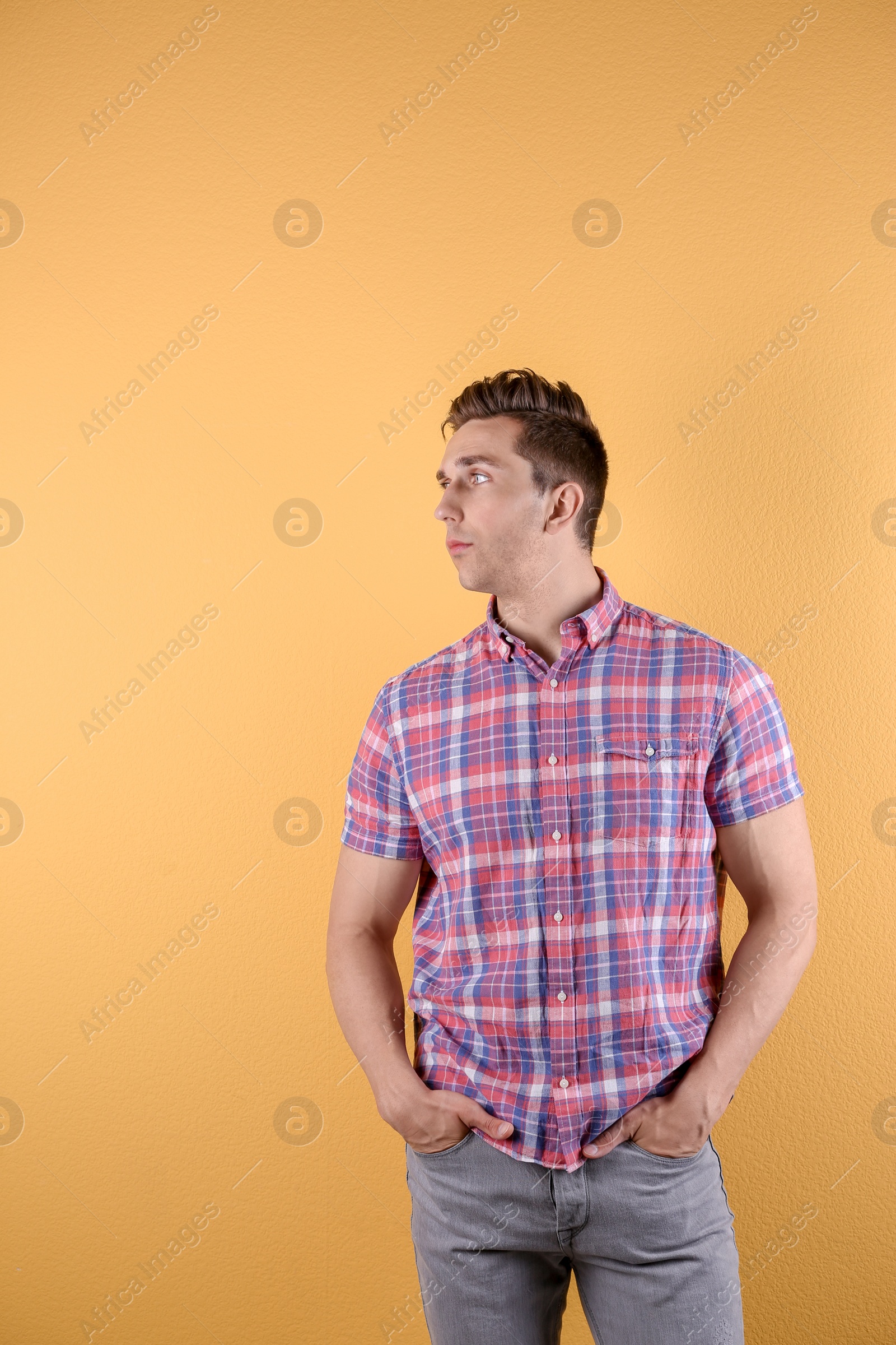 Photo of Handsome young man on color background