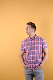 Handsome young man on color background