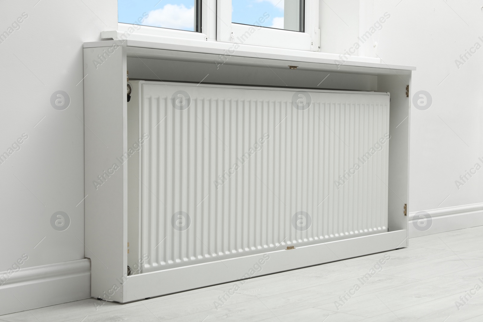 Photo of Modern radiator at home. Central heating system