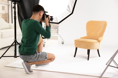 Photo of Young photographer working in professional studio