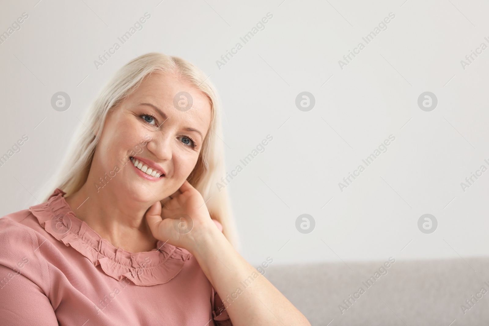 Photo of Portrait of beautiful older woman against light background with space for text