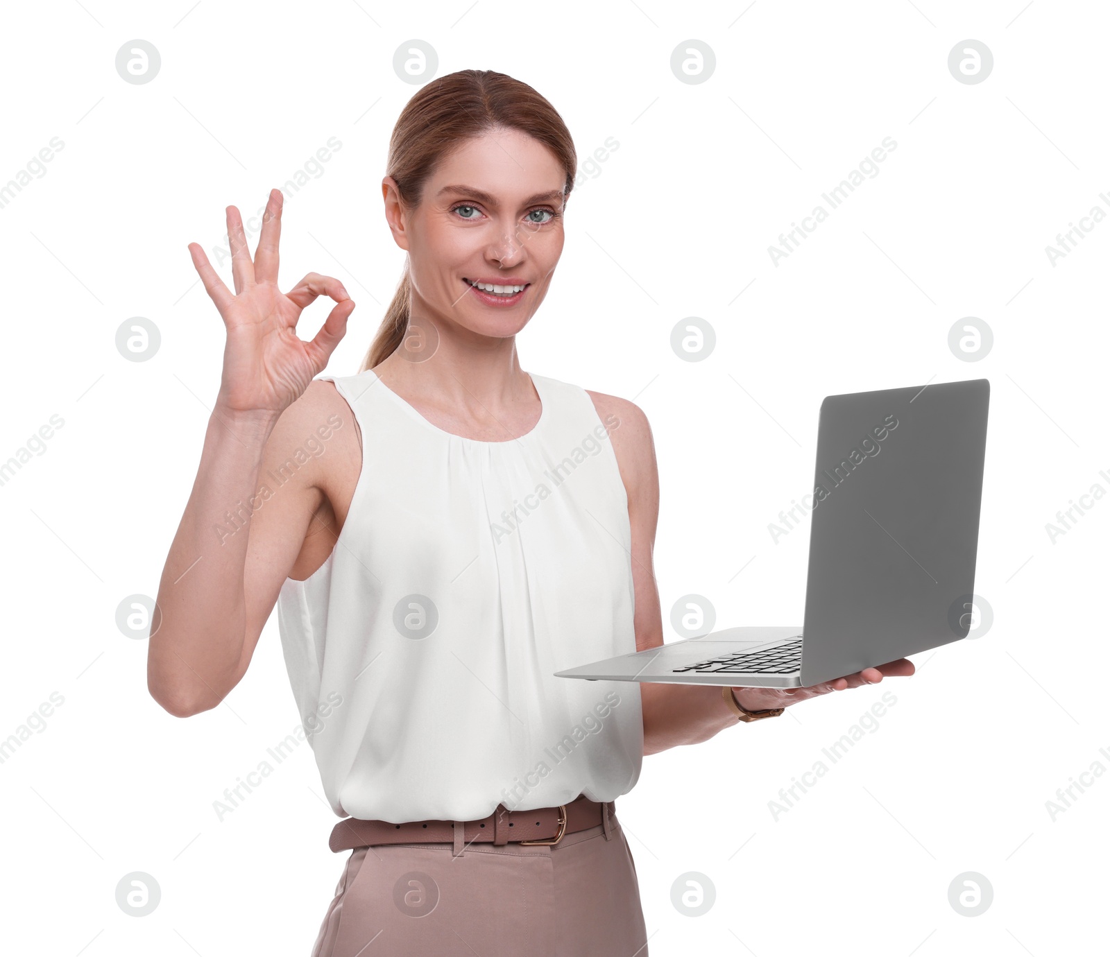 Photo of Beautiful happy businesswoman with laptop showing ok gesture on white background