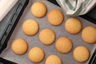 Photo of Delicious Danish butter cookies on baking tray, flat lay